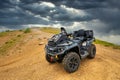BRP Can-Am Outlander quad bike in foggy Caucasus mountains. ATV and SSV travel adventure and nature exploration concept