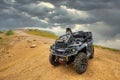 BRP Can-Am Outlander quad bike in foggy Caucasus mountains. ATV and SSV travel adventure and nature exploration concept