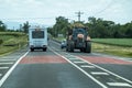 Tractor And Motor Home Traveling On Highway