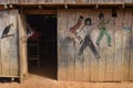 A Bruce Lee style Kung Fu fight scene mural painted on a wooden building in the Amazon rainforest, near Iquitos, Peru