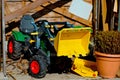 Bruder Tractor parked next to a flower pot outdoors Royalty Free Stock Photo