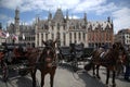 Bruge Belgium. Main Square with horses harnessed to and traps