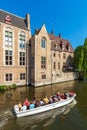 BRUGES, BELGIUM - APRIL 6, 2008: Tourists float on a boat through the Dijver channel Royalty Free Stock Photo