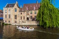 BRUGES, BELGIUM - APRIL 6, 2008: Tourists float on a boat through the Dijver channel Royalty Free Stock Photo