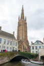 The tower of Church of Our Lady and canal in Brugge, Belgium Royalty Free Stock Photo