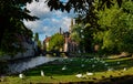 Bruges, Belgium. August 2019. Enchanting postcard view from the vineyard square towards the historic center. Swans in the meadow Royalty Free Stock Photo