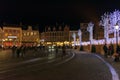 People on the large Market Square Markt in the centre of Bruges, night scene