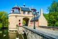 Ezelpoort Donkey's gate medieval entry gate by lake with white swans in Bruges, Belgium