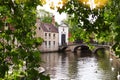BRUGES, BELGIUM - JUNE 14, 2019: Bridge over canal and entrance gate to the Princely Beguinage Ten Wijngaerde Royalty Free Stock Photo