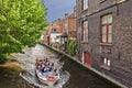 BRUGES, BELGIUM - JUNE 8, 2017: Group of tourists at an excursion on canal of the city Royalty Free Stock Photo