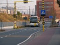 A bus (Van Hool) from De Lijn (company), drives along the train tracks.