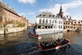 Bruges, Belgium - March 2018: tourists having boat tour on the city canals Royalty Free Stock Photo