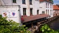 Bruges, Belgium - May 12, 2018: Empty Quayside Jetty For Pleasure Boats On The Canal And At Home Above Water