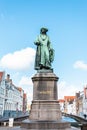 Monument of famous artist Jan Van Eyck on Square Jan van Eyckplein in Bruges, Belgium. Royalty Free Stock Photo