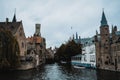 Bruges / Belgium - October 2019: Boat full of tourists on a guided tour through the medieval mysterious city Brugge. UNESCO world