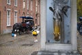 Bruges, Belgium - October 11 2019: Horse-drawn carriage with tourists and Drinking fountain for horses in historic center of Royalty Free Stock Photo