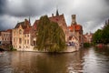 BRUGES, BELGIUM - SEPTEMBER 05, 2018: Canal in Bruges and famous Belfry tower on the background in a beautiful autumn day, Belgium Royalty Free Stock Photo