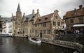 BRUGES, BELGIUM - SEPTEMBER 05, 2018: Canal in Bruges and famous Belfry tower on the background in a beautiful autumn day, Belgium Royalty Free Stock Photo