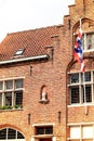 Bruges city symbol, the Brugs Beertje on the facade of the Poortersloge