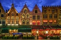 Bruges Grote markt square famous tourist place with many cafe and restaurants in the evening