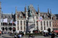 Bruges market square with historic buildings and tourists