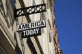 Closeup of america today fashion company over store entrance with blue sky