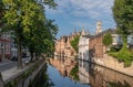 Belfry towers over facades of Groenerei canal, Bruges, Belgium