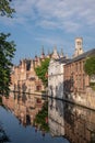 Portrait, Belfry towers over facades of Groenerei, Bruges, Belgium