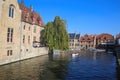 View over water canal on medieval buildings, green tree and boat pier background against clear blue autumn sky Royalty Free Stock Photo