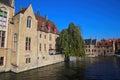 View over water canal on medieval buildings, green tree and boat pier background against clear blue autumn sky Royalty Free Stock Photo