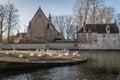 Brugge, West Flanders / Belgium - January 2017: Convent of Sancta Elisabeth Sauve Garde along the river with white swans Royalty Free Stock Photo