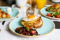 Brunch table with Classic french toast with cheese and ham, fried eggs, vegetables and honey-balsam dressing