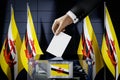 Brunei flags, hand dropping ballot card into a box - voting, election concept