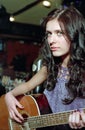 Brunet woman with guitar