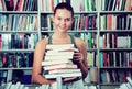 Brunete girl chooses a book in university library Royalty Free Stock Photo