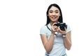 Brunette asian woman taking picture on digital camera isolated on white Royalty Free Stock Photo