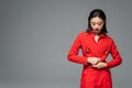 brunette asian woman touching red jacket Royalty Free Stock Photo