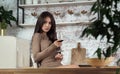 Brunette attractive girl drinking a glass of red wine at kitchen Royalty Free Stock Photo