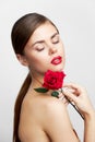 Brunette with bare shoulders Eyes closed flower charm red lips Royalty Free Stock Photo