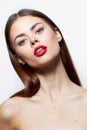 Brunette Bare shoulders red lips head tilted to one side natural look light Royalty Free Stock Photo