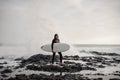 Brunette boy standing with a surf in his hands on the shore on the day Royalty Free Stock Photo