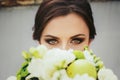 Brunette bride with magic green eyes looks over a green wedding