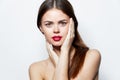 Brunette bright Nude shoulders red lips charm hands on face makeup