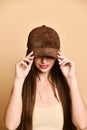 Sexy beautiful brunette woman in a brown suede baseball cap Royalty Free Stock Photo
