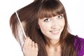 Brunette brushing her hair, in studio