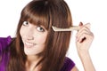 Brunette brushing her hair, in studio