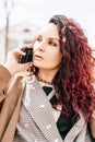 brunette businesswoman talking mobile phone with client. Woman managing business talking via mobile phone sitting Royalty Free Stock Photo