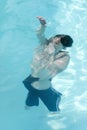 Brunette caucasian boy holding breath under water Royalty Free Stock Photo