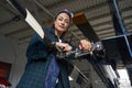 Woman air frame engineer in uniform posing in aviation garage Royalty Free Stock Photo