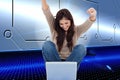 Brunette cheering while using laptop Royalty Free Stock Photo